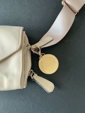 GUESS Cream Crossbody with Gold Logo Medallion and Pink Strap